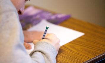 Person writing on paper 