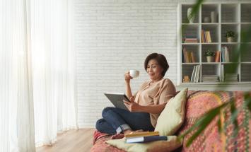 Person looking at a tablet on a couch