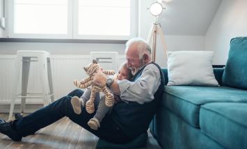 Grandfather playing on the floor with grandchild