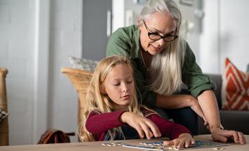 Two generations doing a puzzle together