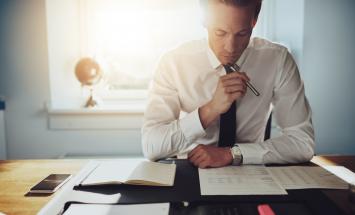 Person looking at papers on desk