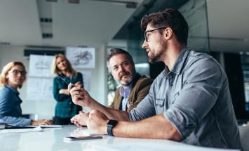 Group of people talking around a table