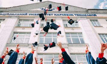 people throwing their graduation caps in the air