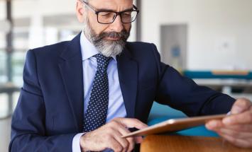 Man accessing COVID-19 Resource Center on tablet