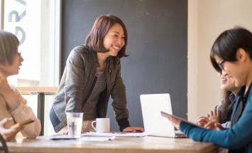 academic member type woman leaning on table