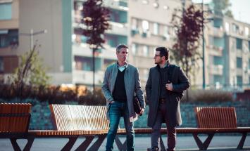 Two people walking next to each other outside