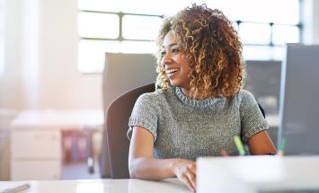 Woman sitting in office chair smiling