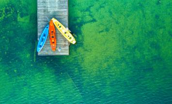 three kayaks on clear water to signify three sustainable investing issues