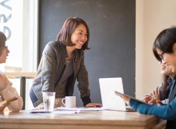 academic member type woman leaning on table