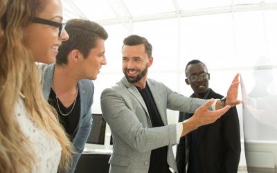 Group of people, talking and looking at a whiteboard