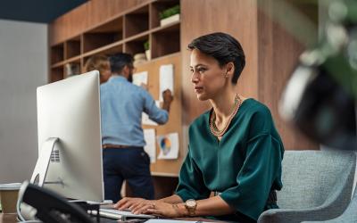 Person in a green shirt working at the computer 