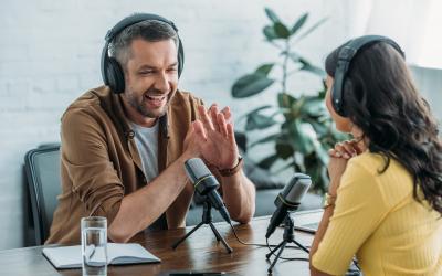 Two people having an interview with microphones