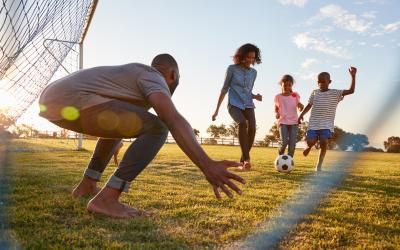 Family playing soccer