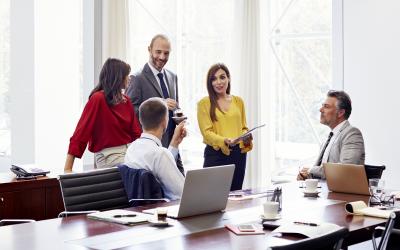 Colleagues connecting and talking in a conference room