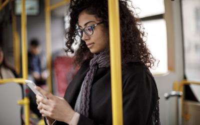 Woman reading on her phone while commuting