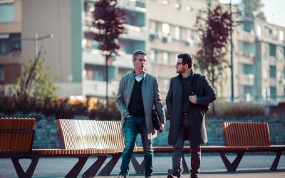 Two people walking next to each other outside