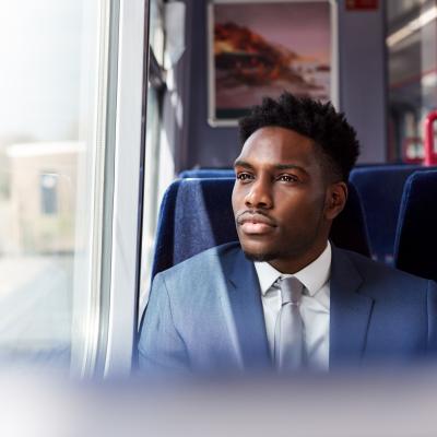 person on train looking out window